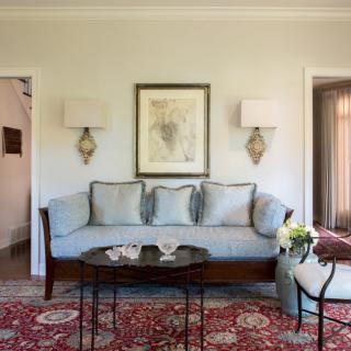 Elegant living room with a sofa, artwork, and a decorative coffee table.