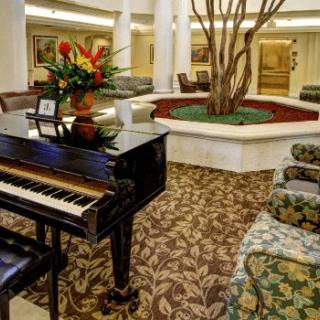 Elegant lobby with a piano and stylish decor.