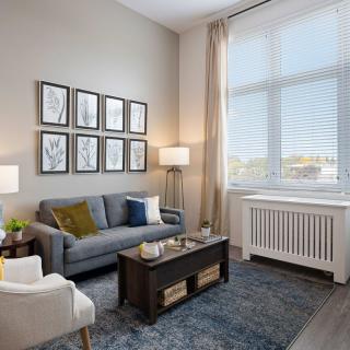 A cozy living room with a modern sofa, coffee table, and wall art.