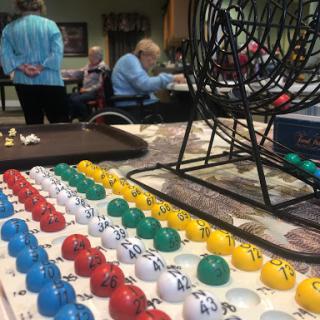 Participants enjoy a lively game of bingo, fostering community and social interaction.