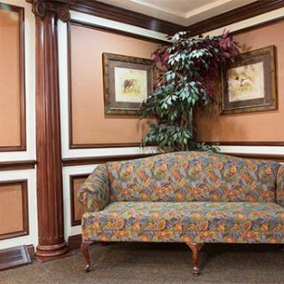A colorful couch in a well-decorated corner of a living space.