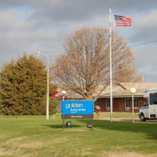 A building with an American flag and a sign that reads 'Culver Community Schools Corporation' on a grassy area.