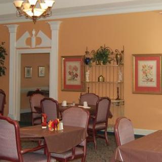A cozy dining room with elegant furniture and warm decor.