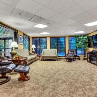 A spacious living room with comfortable seating and large windows.