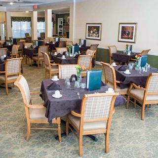 An elegant dining area with neatly arranged tables and chairs, ready for guests.