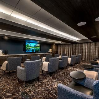 Luxurious home theater with comfortable seating and a large screen.