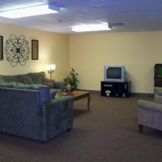 A cozy living room with sofas, a TV, and a coffee table.