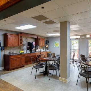 A cozy kitchen and dining area with wooden cabinets and a casual seating arrangement.