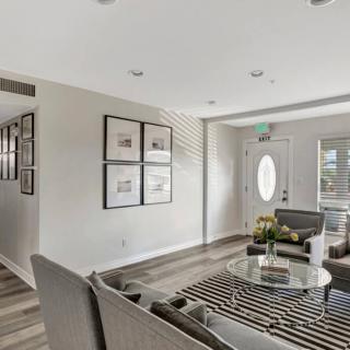 A modern and minimalist living room featuring sleek furniture and contemporary decor.
