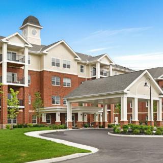 A modern residential apartment complex with a welcoming entrance and well-maintained landscaping.