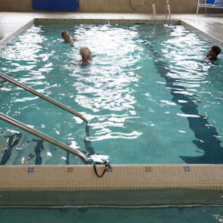 Participants enjoying a session in an indoor swimming pool.