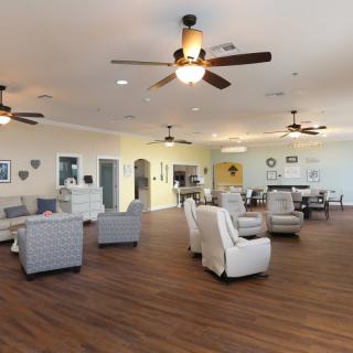 A spacious and inviting living room with comfortable seating and wooden floors.