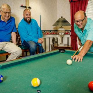 A group of friends enjoying a game of pool together.