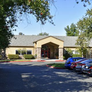 A welcoming exterior view of a building with an inviting entrance and nearby parking.
