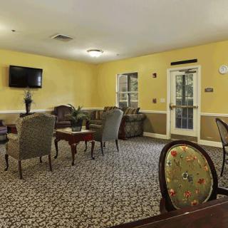 A cozy living room with comfortable seating and a mounted television.