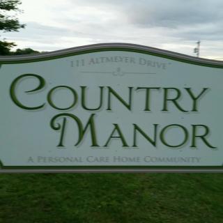 A sign for Country Manor, a retirement care home community.