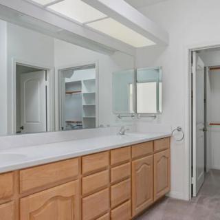 Spacious bathroom with a double sink and ample storage cabinets.