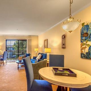 A modern living and dining area with stylish furnishings and bright lighting.