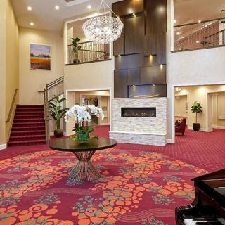 Elegant hotel lobby with a grand staircase and modern decor.