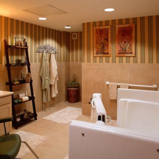 A modern bathroom with a walk-in bathtub, striped wallpaper, and a ladder shelf holding towels.