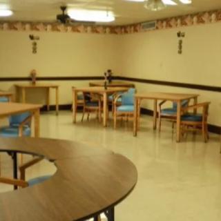 An empty dining area with tables and chairs arranged neatly.