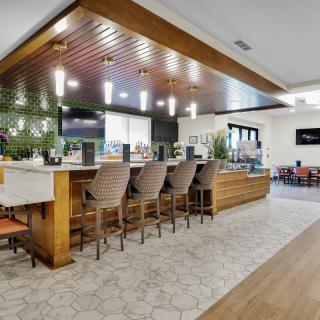 A modern bar area with stylish seating and lighting.