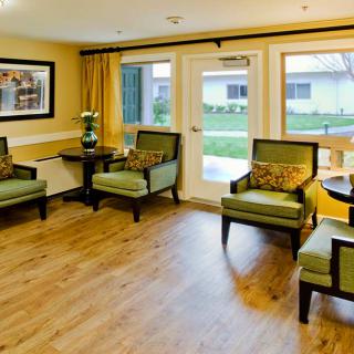 A cozy waiting room with comfortable seating and large windows.
