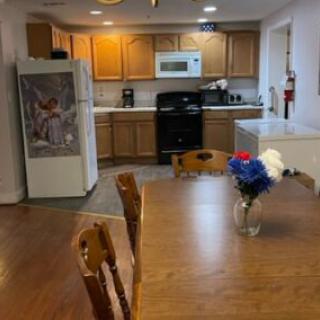 A cozy kitchen and dining space featuring wooden elements and essential appliances.