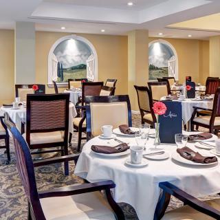 An elegant dining room with neatly arranged tables and chairs.
