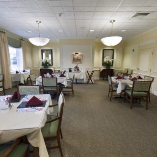 An elegant dining room setup with neatly arranged tables and chairs.