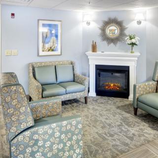 A cozy living room with comfortable seating, a decorative fireplace, and tasteful decor.