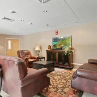 A cozy living room with sofas, a television, and decorative elements.