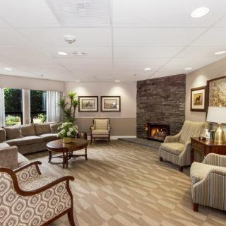 A cozy living room with a fireplace, comfortable seating, and elegant decor.