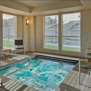 A serene indoor pool area with modern design, offering a relaxing space for wellness and leisure.