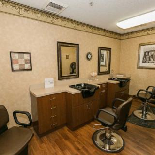 A cozy hair salon interior with styling chairs and mirrors.