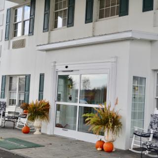 A charming entrance adorned with fall decorations and pumpkins.
