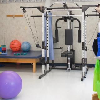 A gym setup with various fitness and exercise machines.