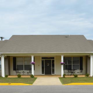 A single-story residential house with a front porch and symmetrical design.