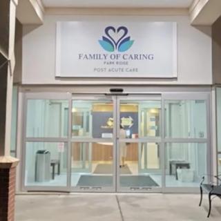 Entrance to a facility with glass doors and a sign that reads 'Family of Caring, Healthcare and Rehabilitation.'