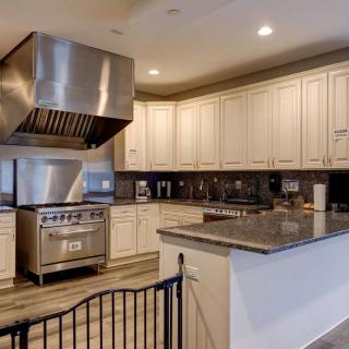 A modern kitchen with stainless steel appliances and wooden cabinets.