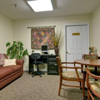 A cozy office space with a sofa, computer desk, and decorative elements.