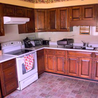 A kitchen with wooden cabinets and modern appliances.