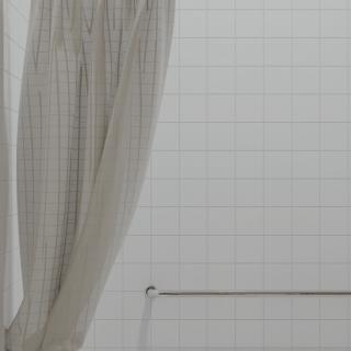 A bathroom with a light-colored curtain and towel rack against a tiled wall.