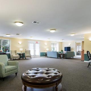 A spacious lounge area with comfortable seating and soft lighting.