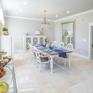 A beautifully decorated dining room with elegant furnishings and a chandelier.