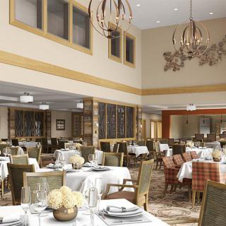 An elegant restaurant dining area with neatly arranged tables and sophisticated chandeliers.