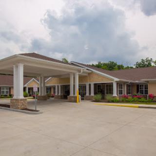 A welcoming entrance to a healthcare facility, featuring modern architecture and well-maintained grounds.