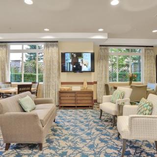 A well-decorated living room with comfortable seating and a television.