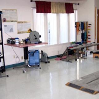 A physical therapy room equipped with various rehabilitation tools and exercise machines.