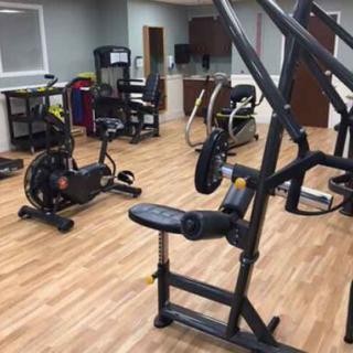 A well-equipped gym with various exercise machines.